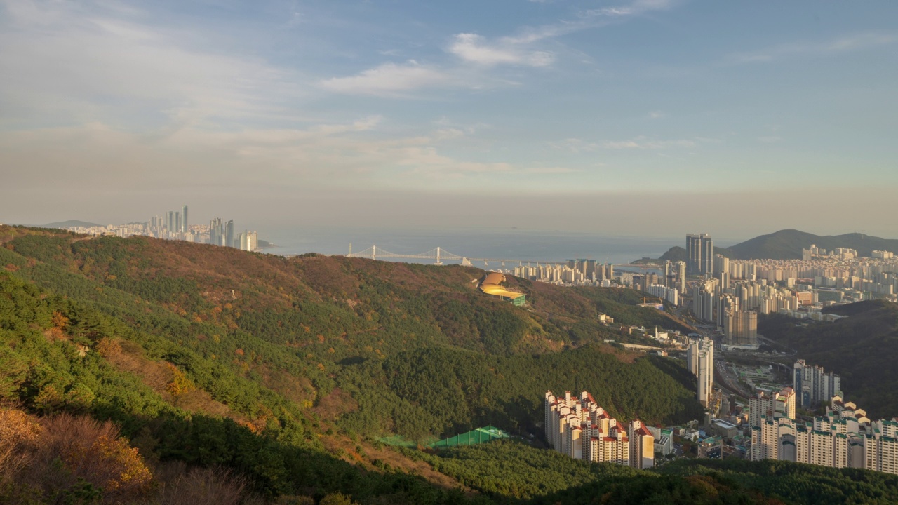 在韩国釜山，从黄陵山观景廊观看海洋城市和广达大桥周围的市区日间风景视频素材