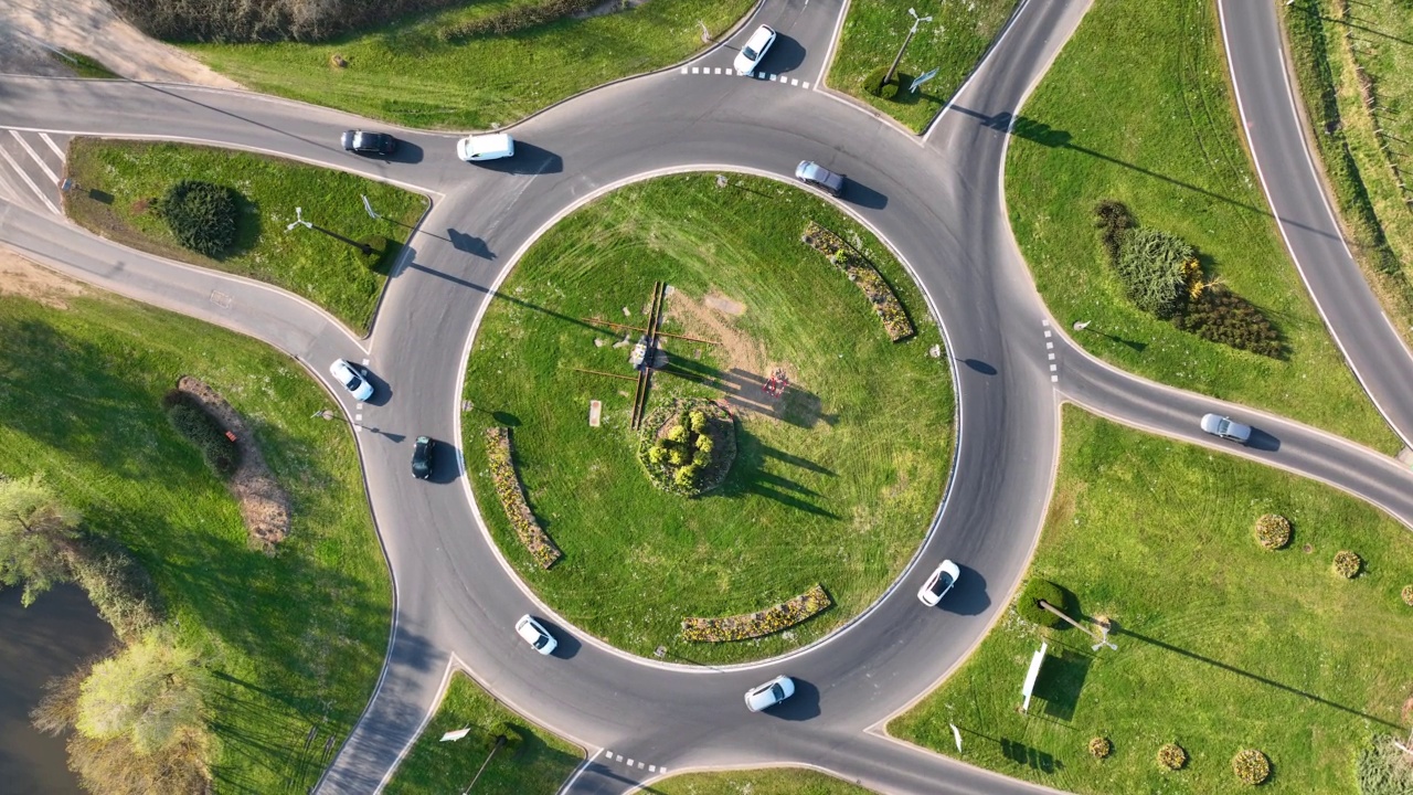 快速移动的繁忙交通的道路回旋交叉路口鸟瞰图。城市环形交通十字路口视频素材