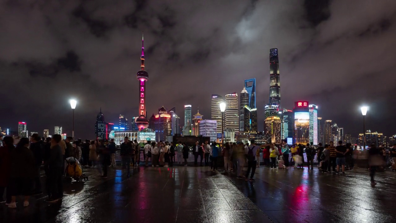 4k Time lapse:中国上海外滩风景名胜地陆家嘴摩天大楼灯光秀拍摄人群合影视频下载