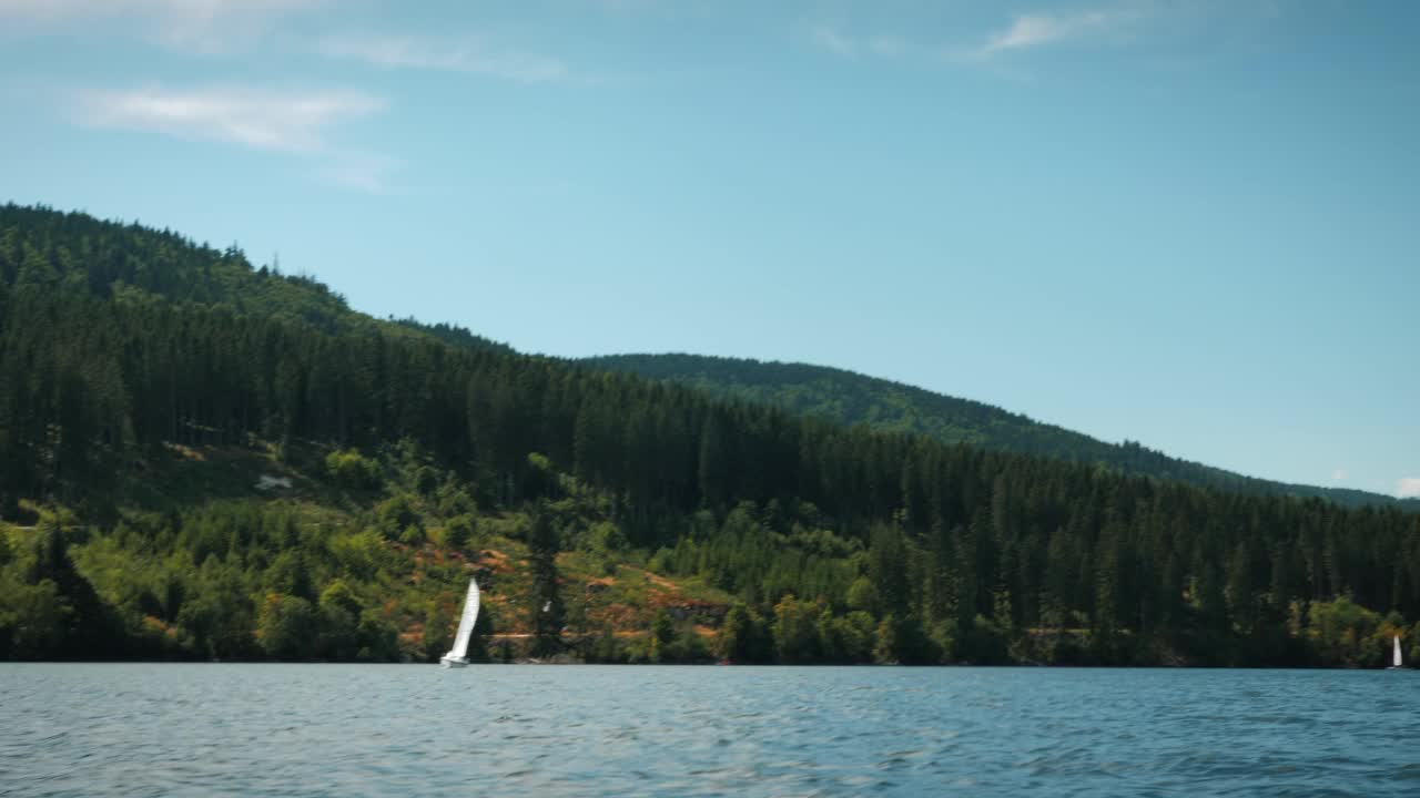 湖上航行。在山间湖上泛舟，青山在天边。暑假的概念。旅游与旅游理念。清澈的山湖视频素材