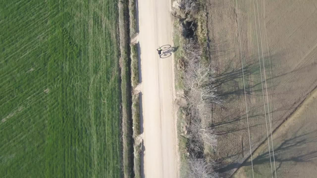 无人机拍摄到一个骑自行车的人在乡村道路上骑车。无人机在托斯卡纳视频素材