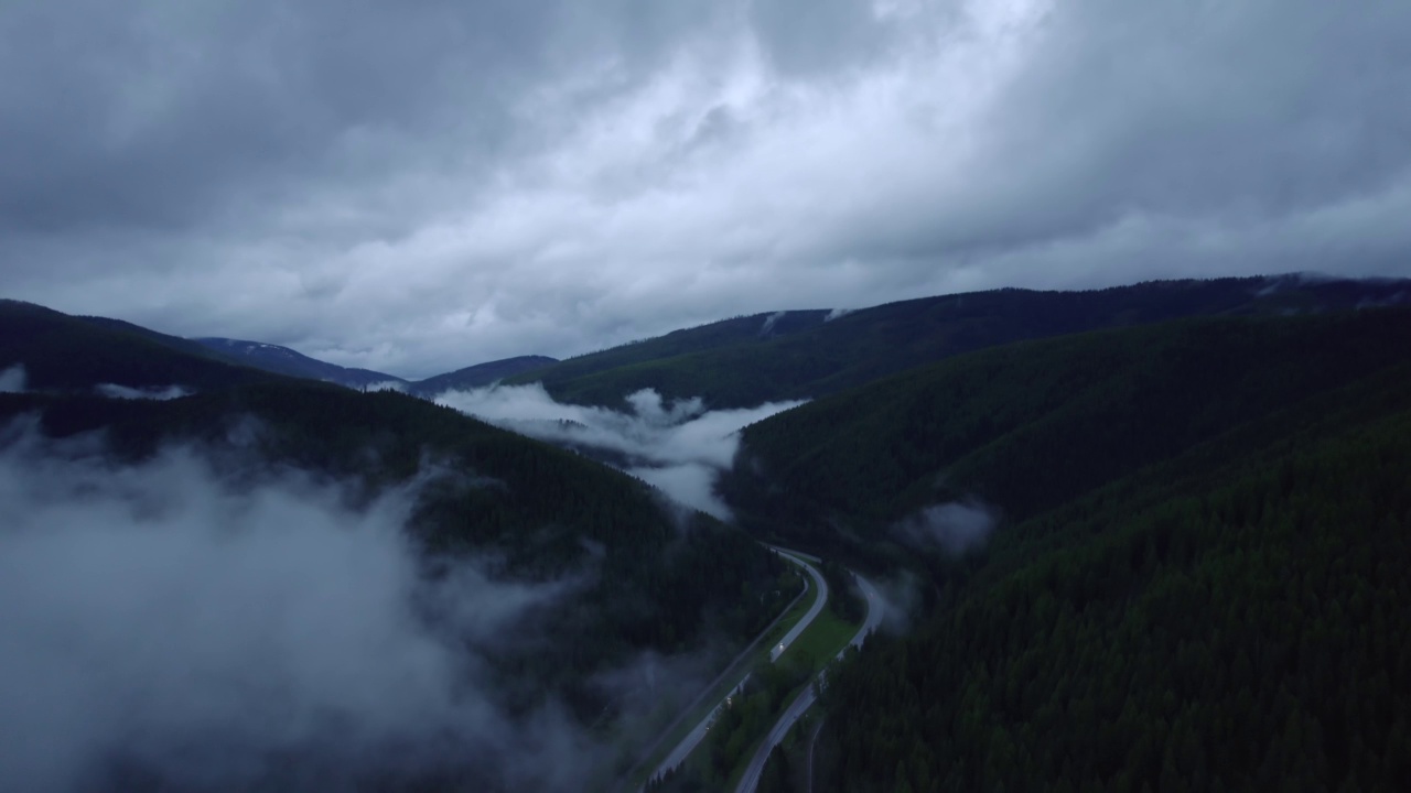 在山区的雨天，汽车和卡车在高速公路上行驶。视频素材