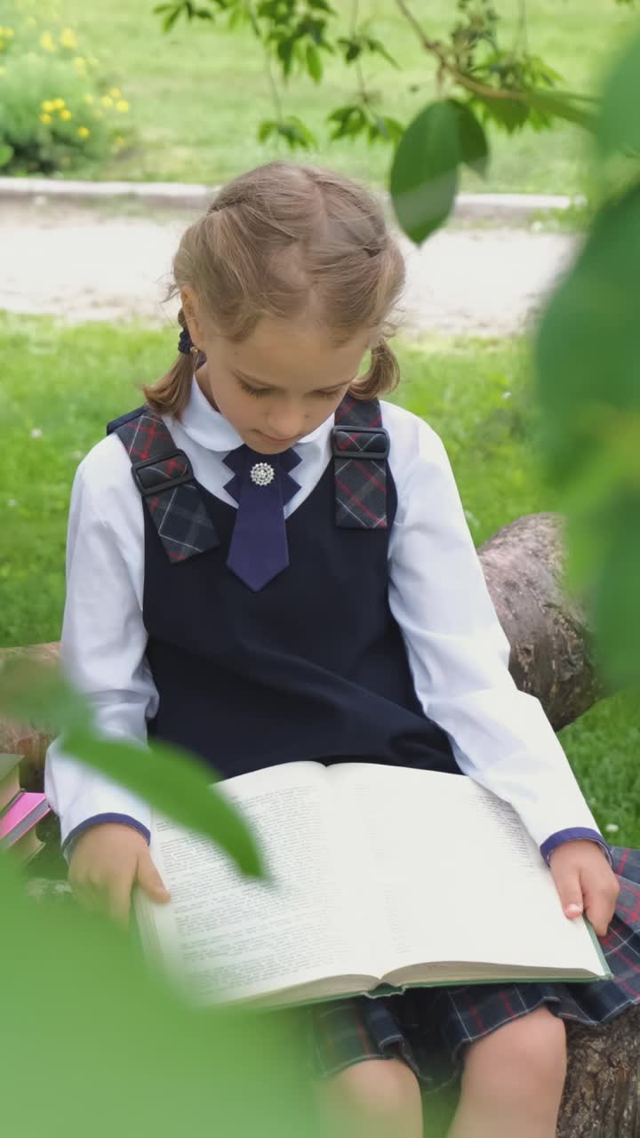 可爱的女学生在树上看书视频素材