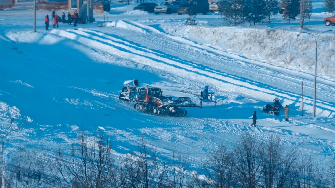 在山坡上，雪地车为滑雪者准备下山视频素材