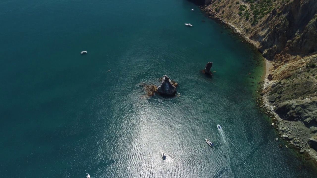 平静海面上的空中游艇。豪华邮轮旅行。从上面看，深蓝色的水面上有白色的小船。航拍的富有的游艇航行在海上。在豪华船上的夏季之旅视频素材