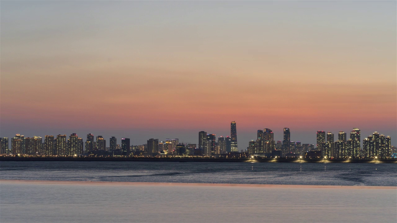 松岛国际城的日落，浦项制铁大厦，多功能公寓，西海和泥地的夜晚/韩国仁川延寿区视频素材