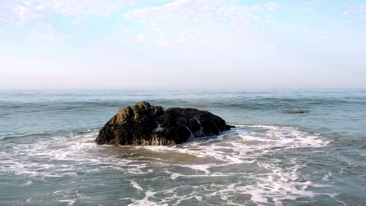 4K无人机库存视频的海滩马里布海滩北部的海浪撞在岩石上视频素材