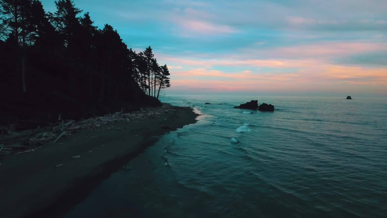 从空中向前看，日落时海浪与天空映衬的天然岩石的美丽景色——俄勒冈州的Siuslaw国家森林视频素材