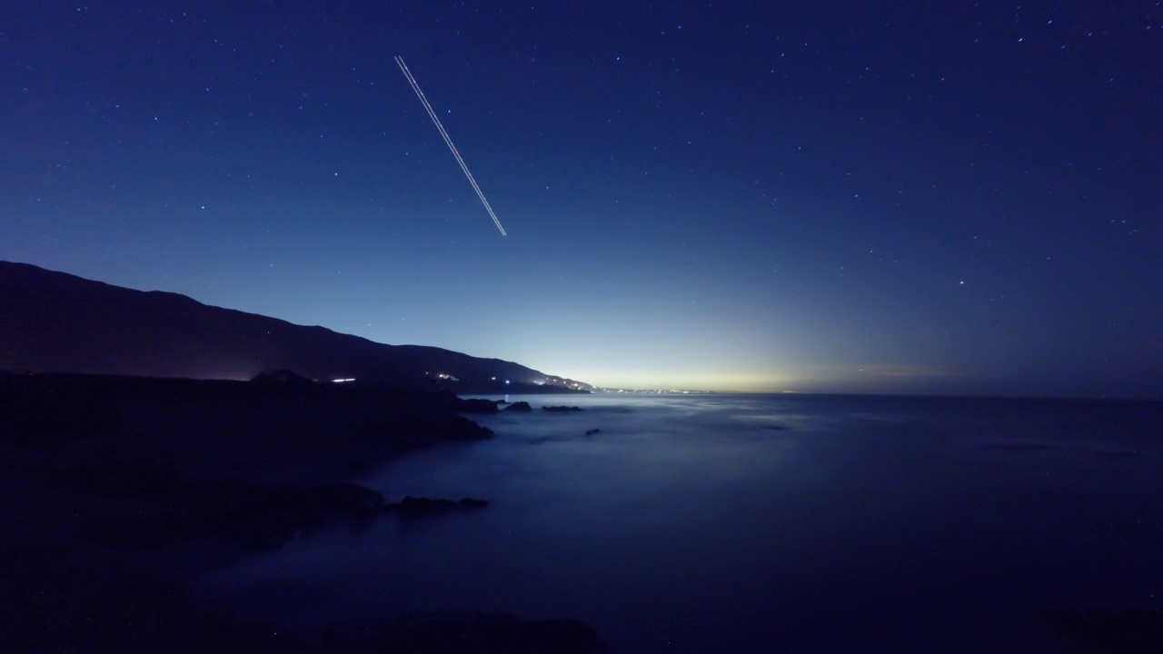 夜晚，星光闪烁的轨迹在山峦和海洋上移动——加利福尼亚州约书亚树视频素材