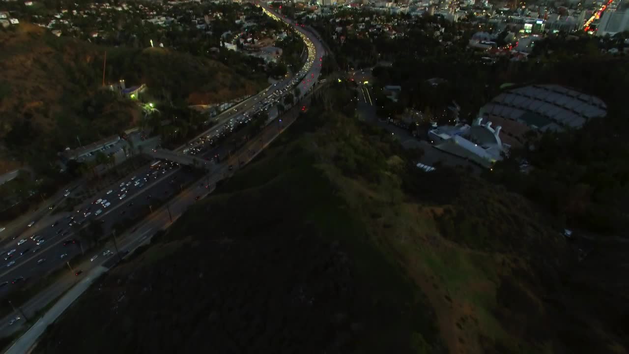 空中倾斜拍摄的照明汽车在现代城市的道路上移动在黄昏-洛杉矶，加利福尼亚州视频素材