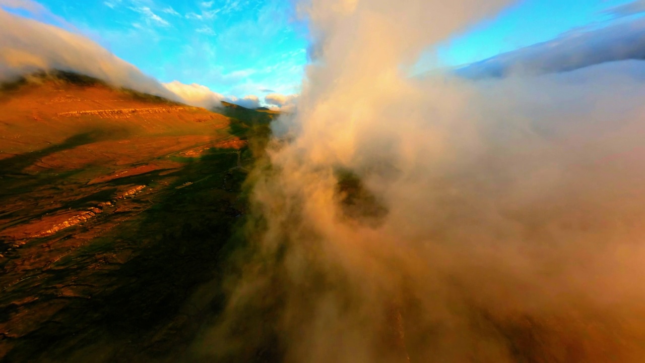 空中向前倾斜向下拍摄的云层在岛屿景观在日落-法罗群岛，丹麦视频素材