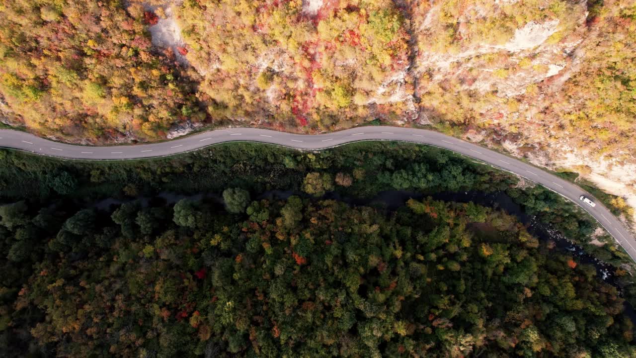 一条穿过峡谷的高速公路，峡谷上画满了秋色视频素材