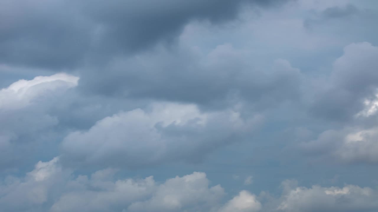 蓬松的雨云在时间推移中快速移动。傍晚，天空背景多云。时光流逝，天空中美丽的云，头顶上戏剧性的风暴云视频素材