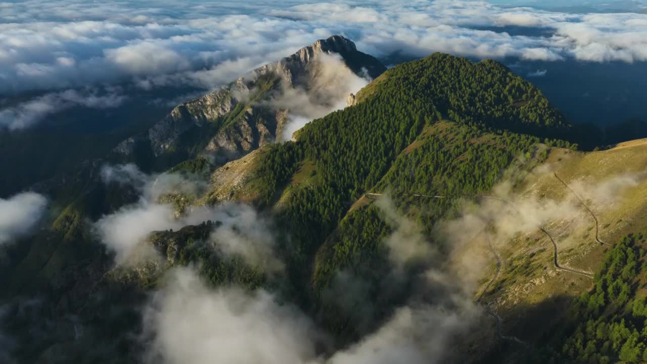 空中时间间隔显示日出时环绕山脉的低空移动云视频素材