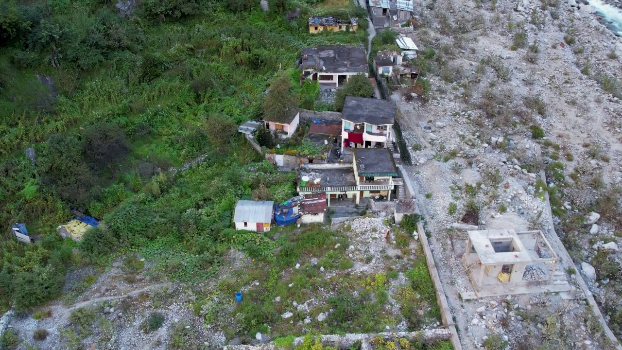 在印度北阿坎德邦的Chamoli地区，沿着冰川河流的喜马拉雅村庄的4K空中无人机库存视频视频素材