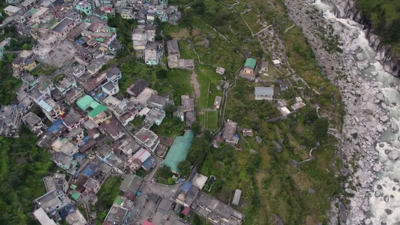 在印度北阿坎德邦的Chamoli地区，沿着冰川河流的喜马拉雅村庄的4K空中无人机库存视频视频素材