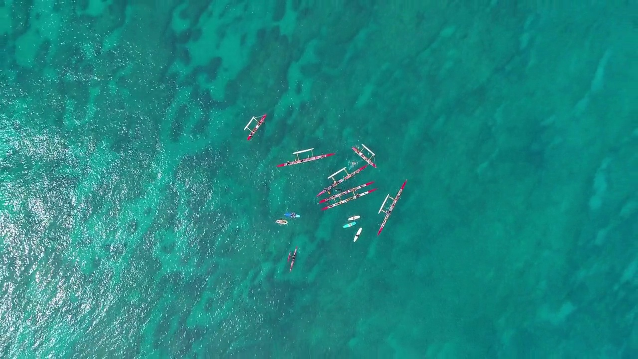 空中拍摄的游客在绿松石海上的夏威夷独木舟上，无人机在阳光明媚的日子里向上飞行-夏威夷瓦胡岛视频素材