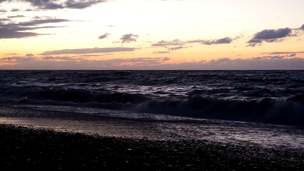 海浪拍打着海岸。海边的日落。视频下载