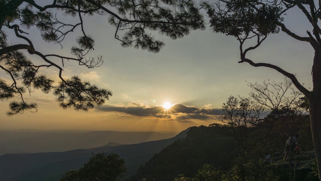 夕阳西下，许多游客成群结队地去看日落，山和树构成了画面。视频素材