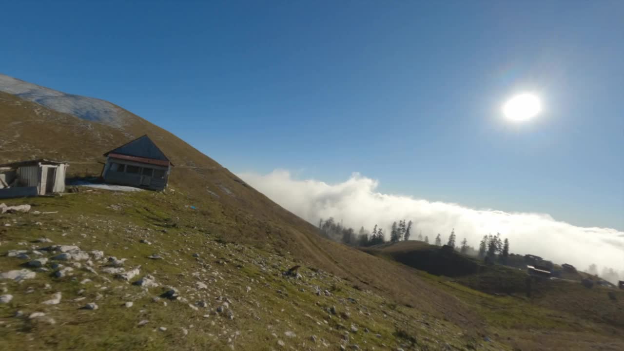 航拍运动FPV无人机飞行在风景如画的丘陵地形与乡村房子阿布哈兹视频素材