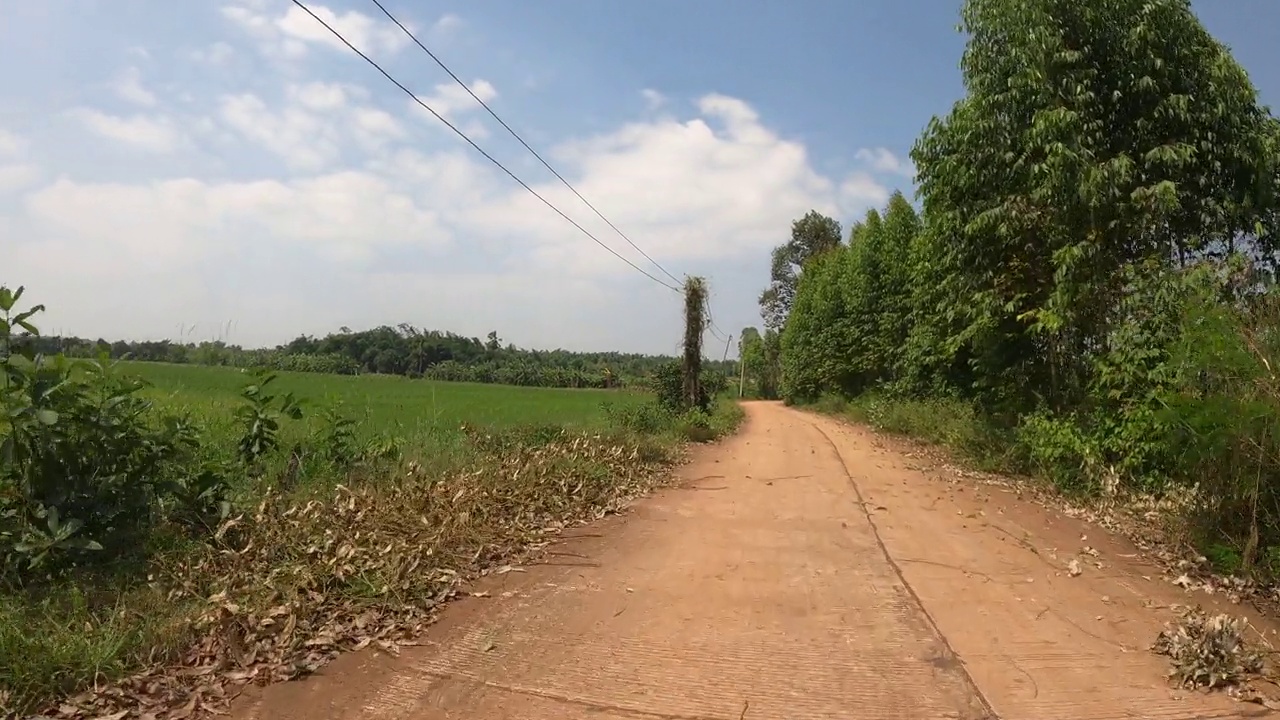 在土路上奔跑的观点。越野卡车的车轮在尘土飞扬、干湿泥泞的肮脏道路上行驶。在偏僻的地方旅行的观点视频素材