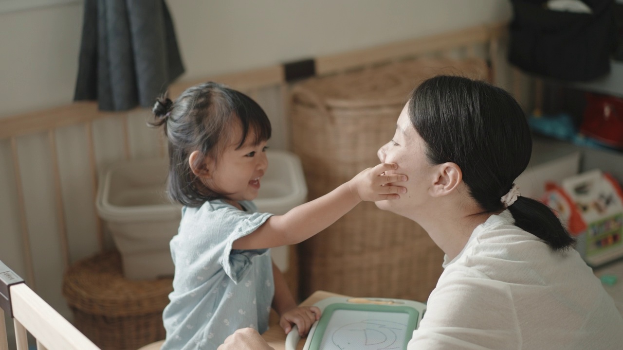 积极的情感亚洲女婴喜欢在家跟妈妈学画画蒙台梭利教育家庭生活理念视频素材