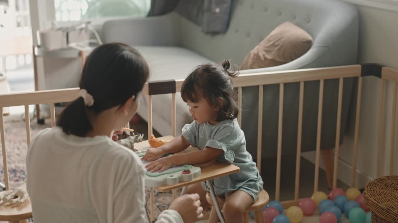 积极的情感亚洲女婴喜欢在家跟妈妈学画画蒙台梭利教育家庭生活理念视频素材