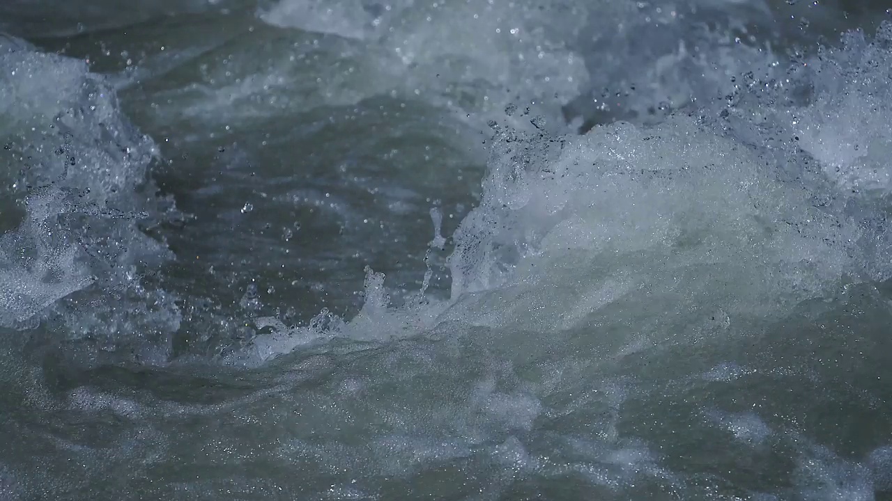 近距离的汩汩的水在鹅卵石在一条河视频素材