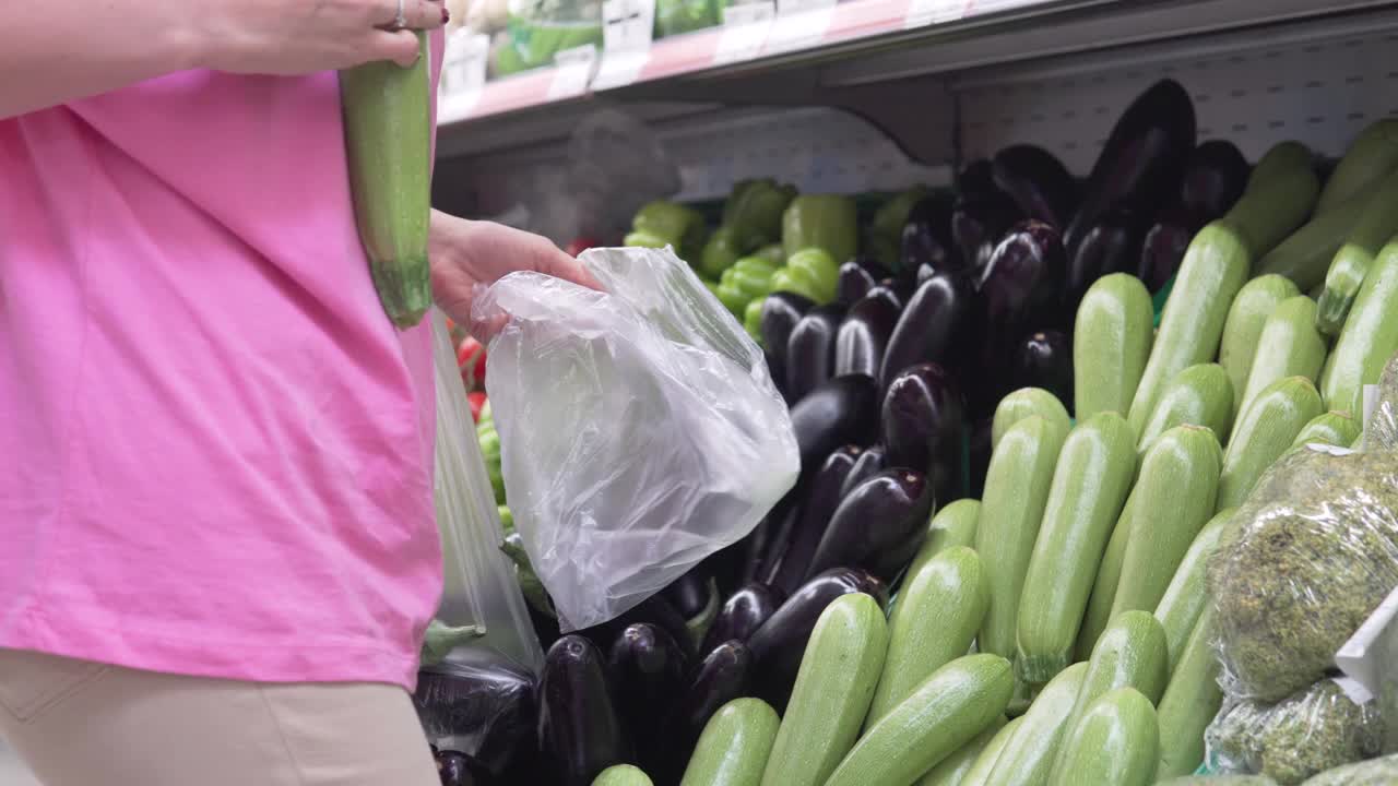 一名妇女在商店购买农场西葫芦视频素材