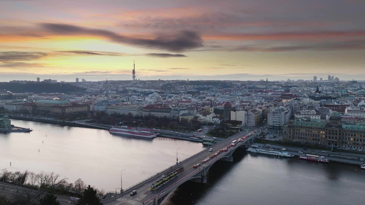 Early sunrise Prague Štefánik Bridge traffic bordering old town and new town with traffic at Vltava, city river and bridge traffic ship on the water skyline视频下载