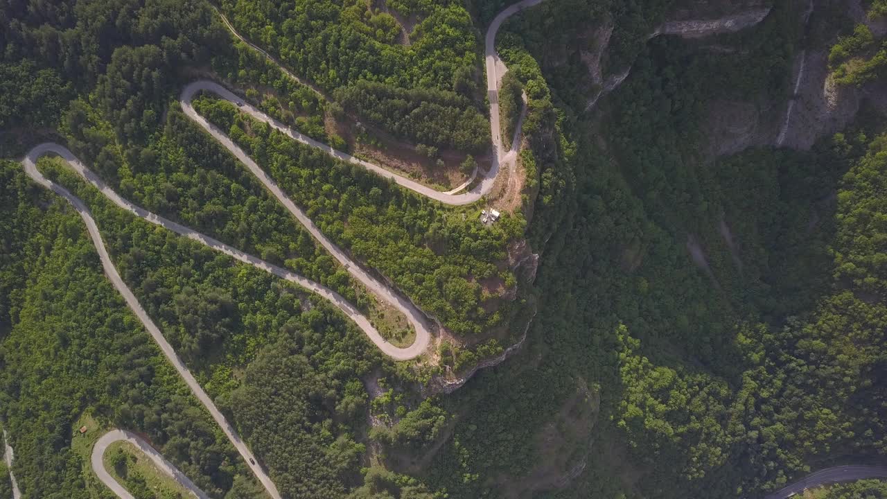 在阳光明媚的日子里，鸟瞰乡间蜿蜒的道路视频素材