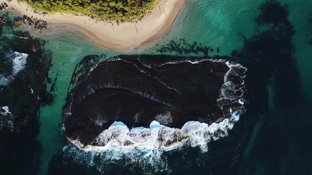 沿海场景的鸟瞰图，海浪冲到海滩和岩石上视频素材