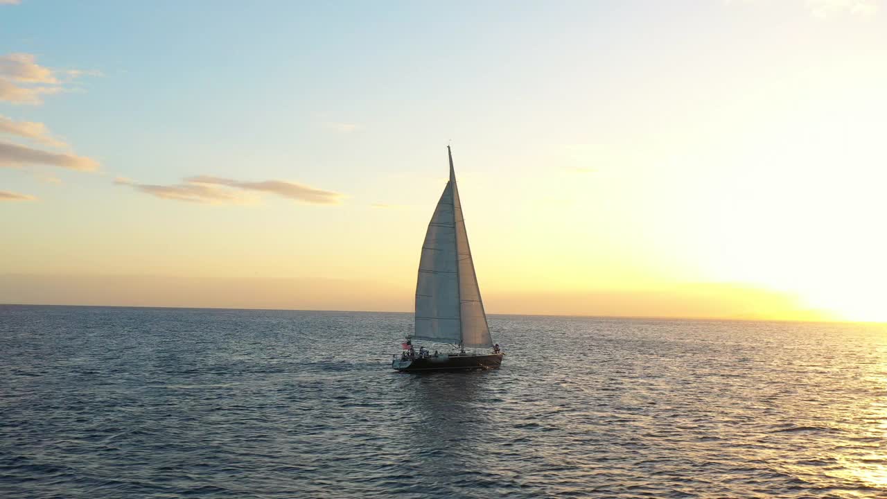 航拍拍摄的游客在海上航行的航海船在日落度假-瓦胡岛，夏威夷视频素材