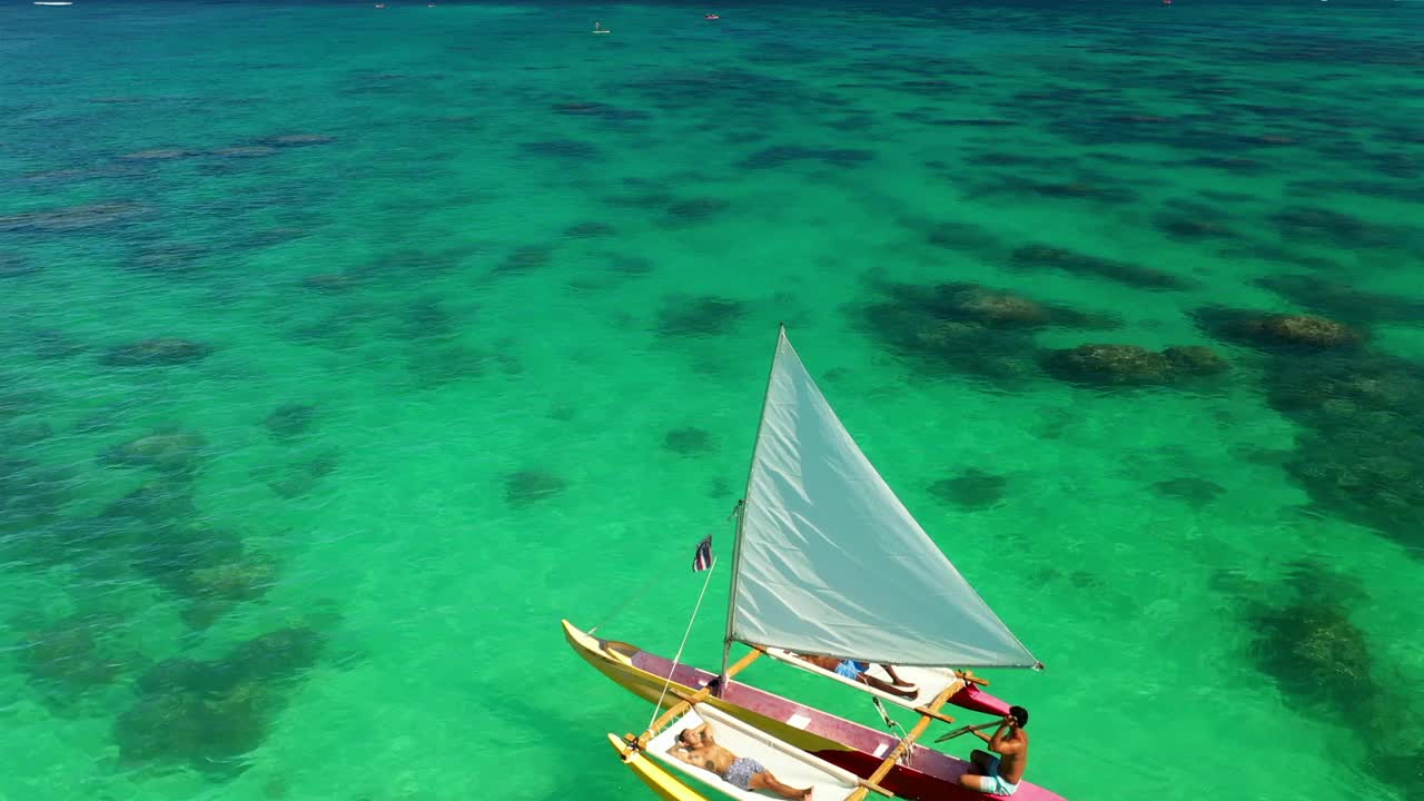 男人在帆船上放松在蔚蓝的大海与地平线对天空-瓦胡岛，夏威夷视频素材