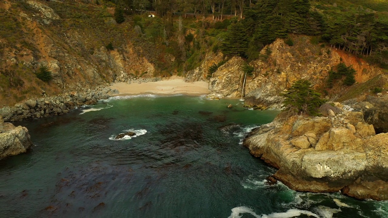 空中风景拍摄瀑布在悬崖上的海滩，无人机在海上向后飞行-旧金山，加利福尼亚视频素材