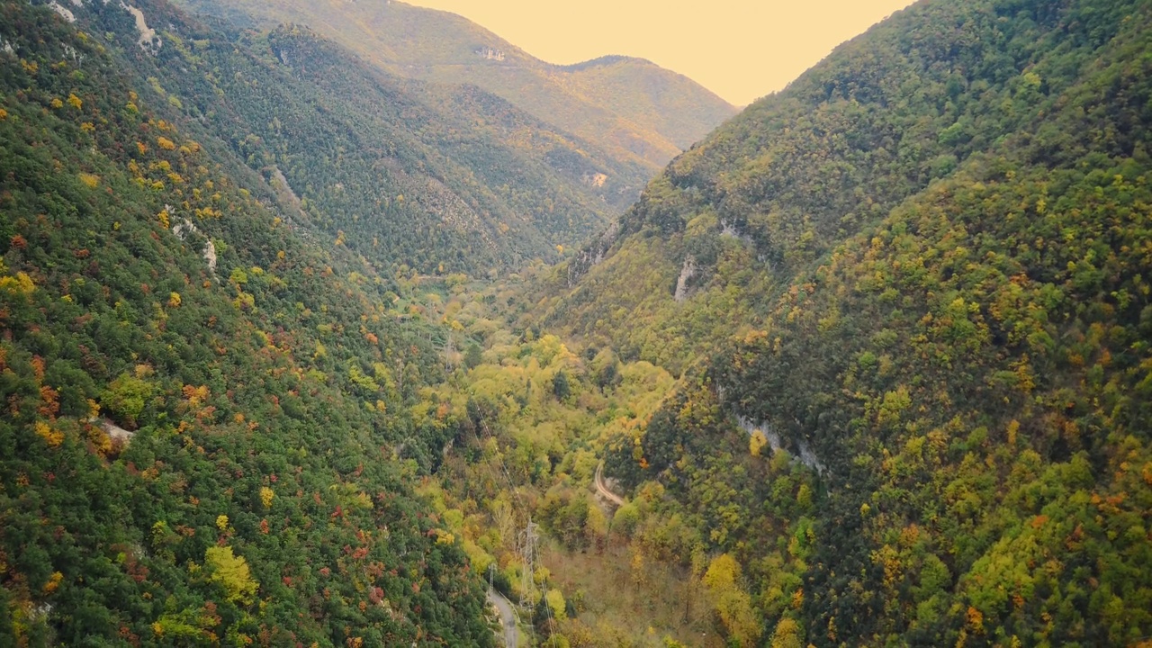 空中无人驾驶飞机超延时美丽的热带山谷之间的山。初升的太阳的第一缕光线穿透了云雾。夕阳最后的余晖照在树冠上。视频素材