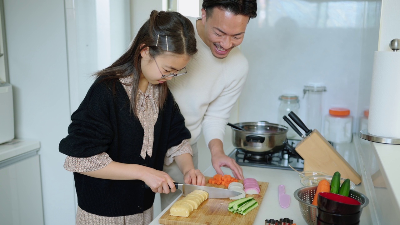 女儿在厨房做饭，父亲在帮她视频素材