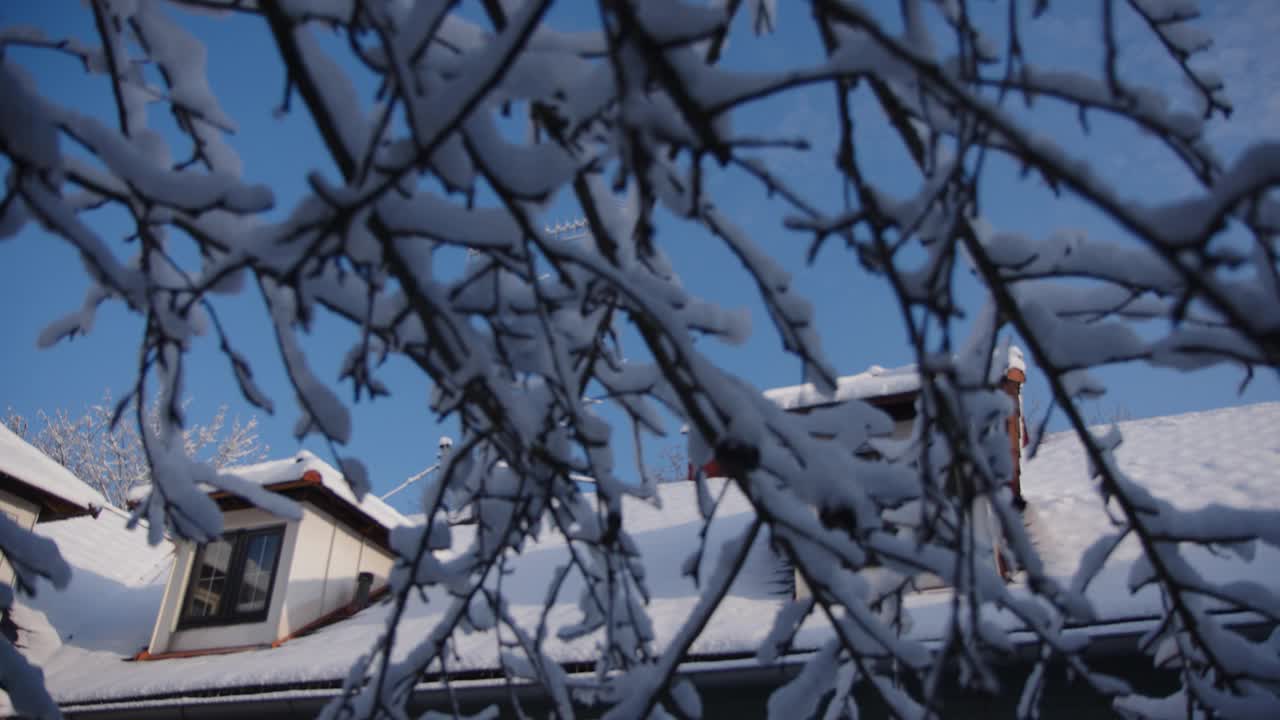 积雪覆盖的屋顶，冬天有天窗和烟囱视频素材