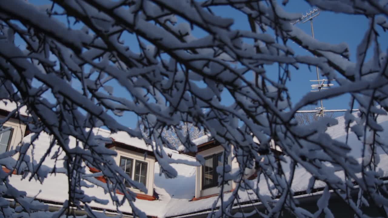 积雪覆盖的屋顶，冬天有天窗和烟囱视频素材