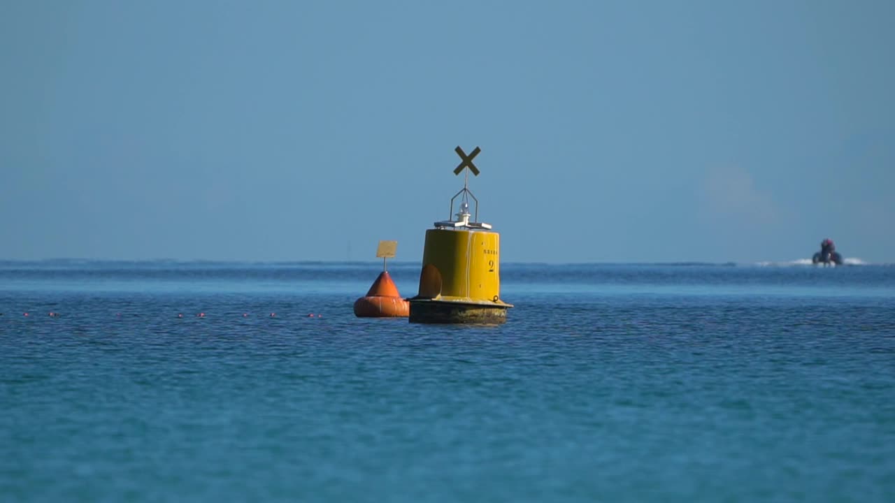 阳光灿烂的日子，航海浮标在海浪中移动——慢镜头视频下载