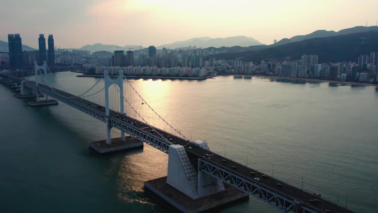 ▽日落=在釜山水永区海云台区市中心广阿里海滩的广安达桥上行驶的汽车视频素材