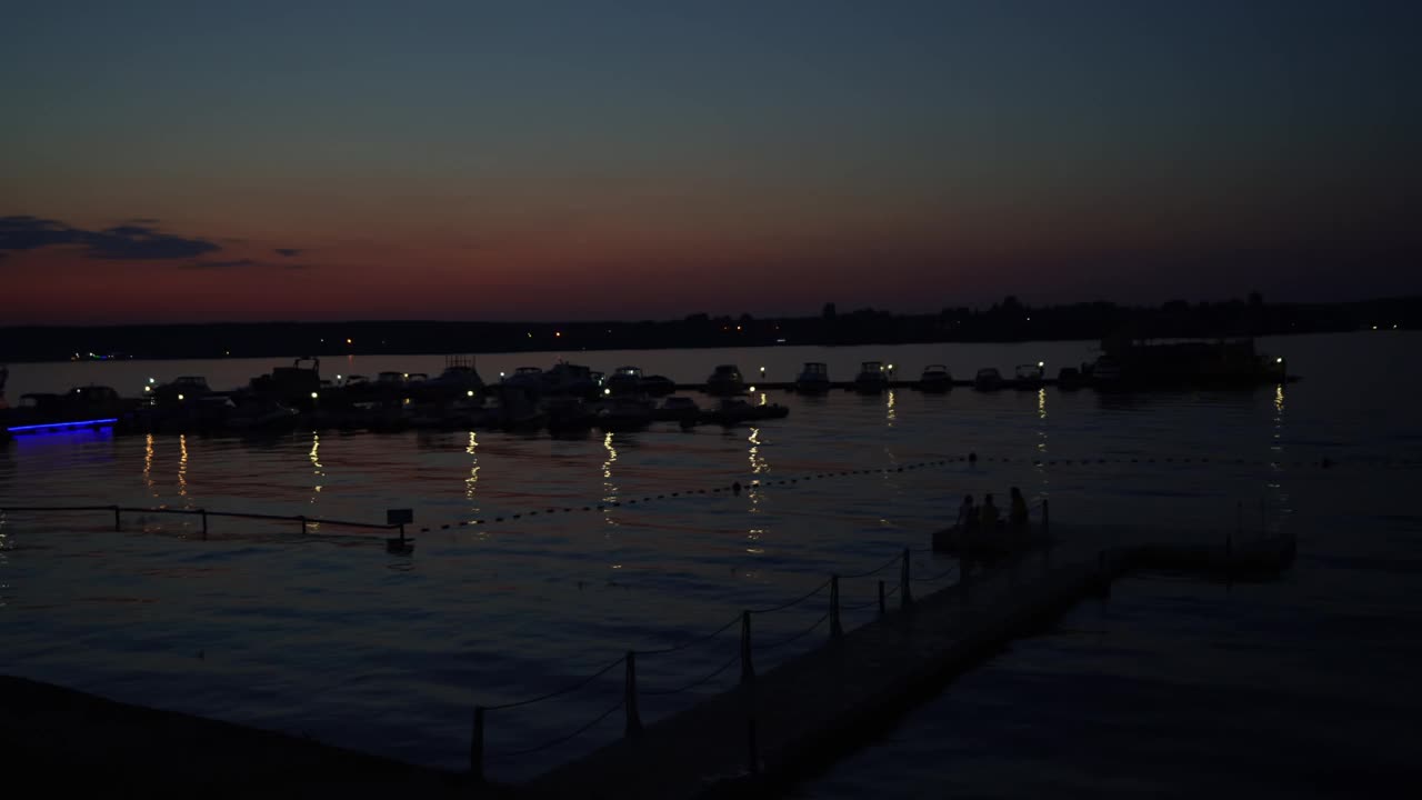 海湾，码头有船，游艇在水面上夕阳西下视频素材