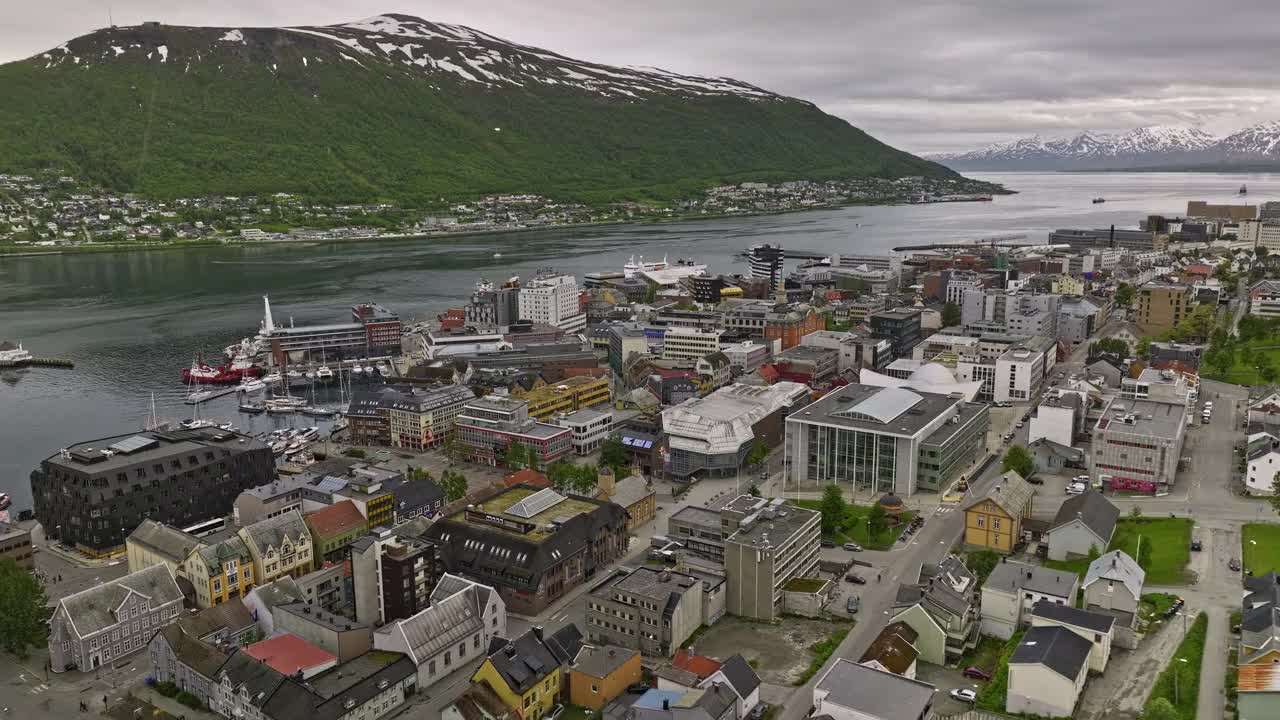 Tromsø Norway Aerial v8 drone flyover central downtown neighborhood capturing cruise ship docked at the harbor and beautiful nature mountain landscape - Shot with Mavic 3 Cine - June 2022视频素材