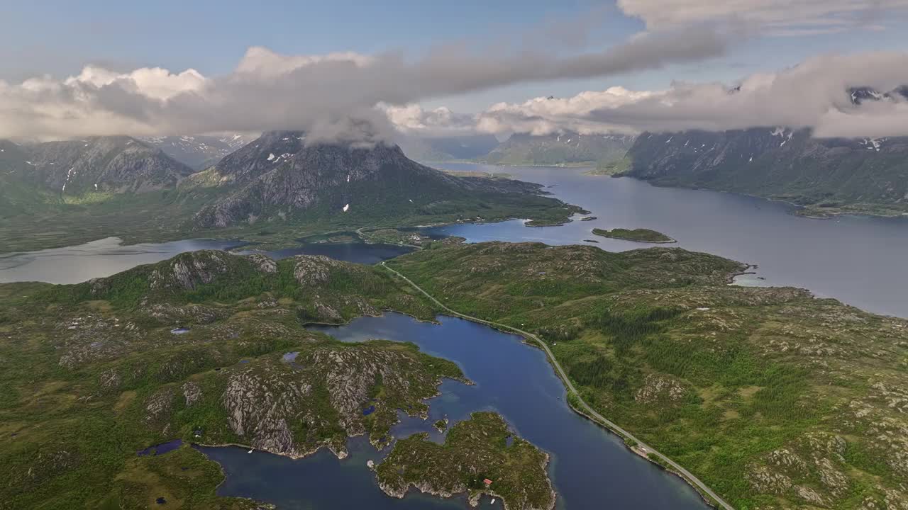 Djevelporten Norway Aerial v3 high altitude panning view above husvågen bay overlooking at hammerstad camping ground surrounded by mountainscape and coastal inlet - Shot with Mavic 3 Cine - June 2022视频素材