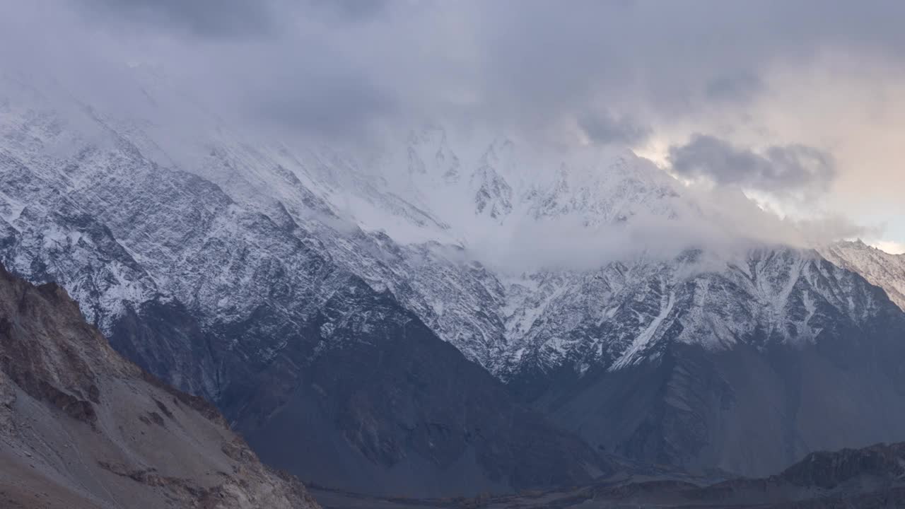 在巴基斯坦罕萨山谷的秋天，喀喇昆仑山脉雪山壮丽景色的时间流逝移动云日出场景视频素材