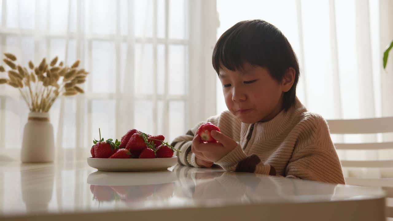 可爱的孩子吃草莓视频素材