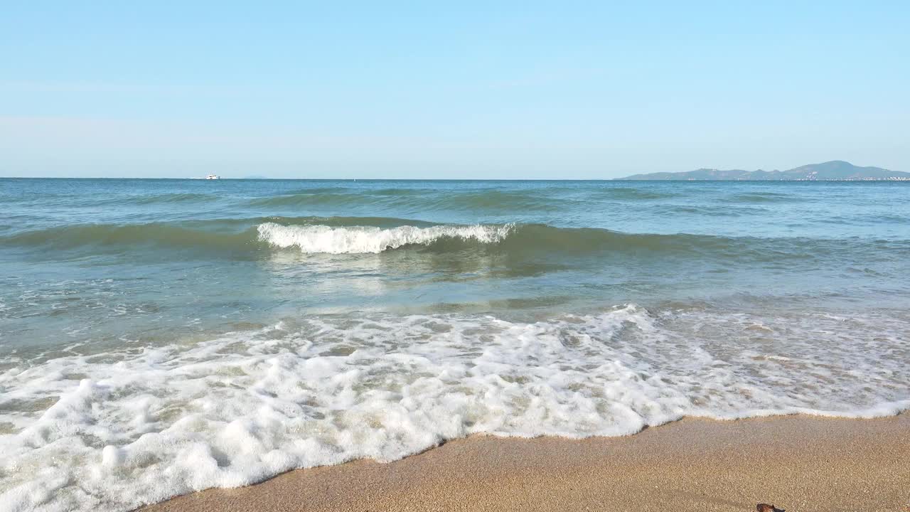 海浪冲击着蓝天的沙滩视频素材