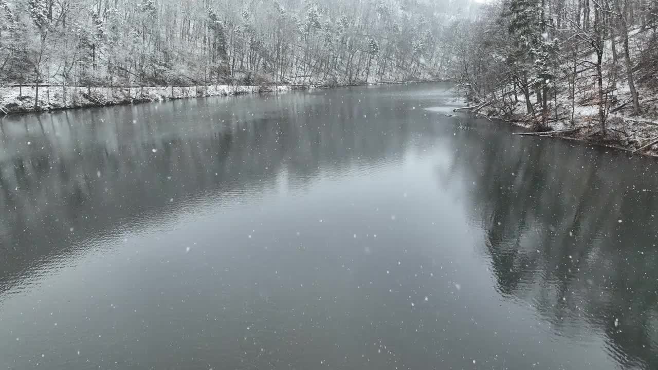 雪湖上的无人机在下雪时飞过视频下载