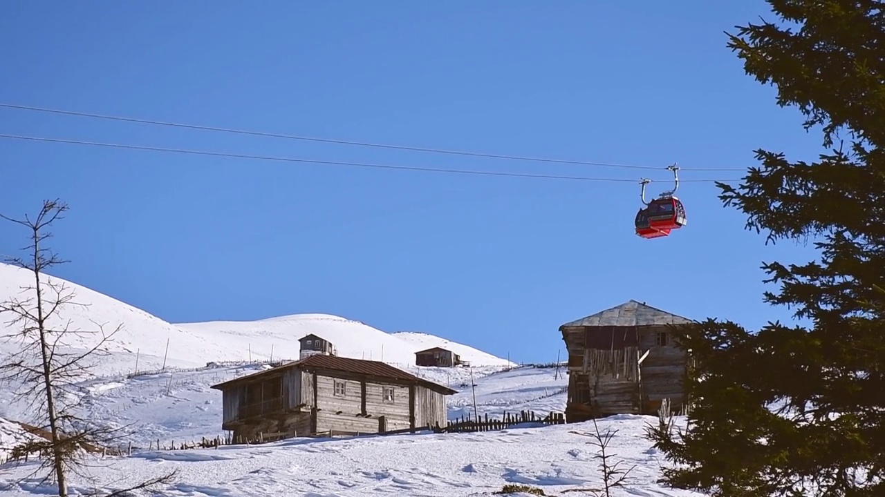 冬季在阿贾拉山脉的Goderdzi滑雪场的缆车和老木屋视频素材