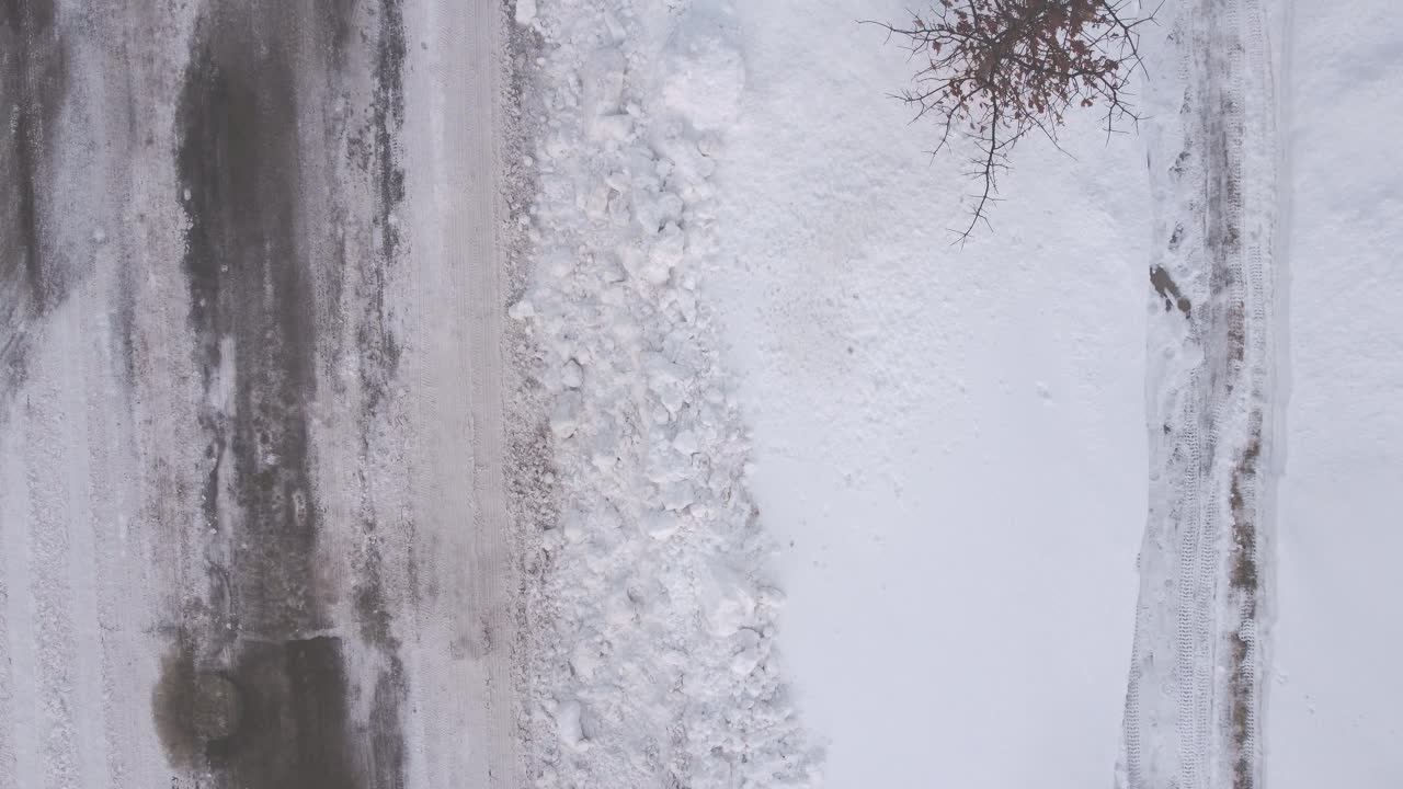 无人机俯瞰有雪堤的住宅道路视频下载